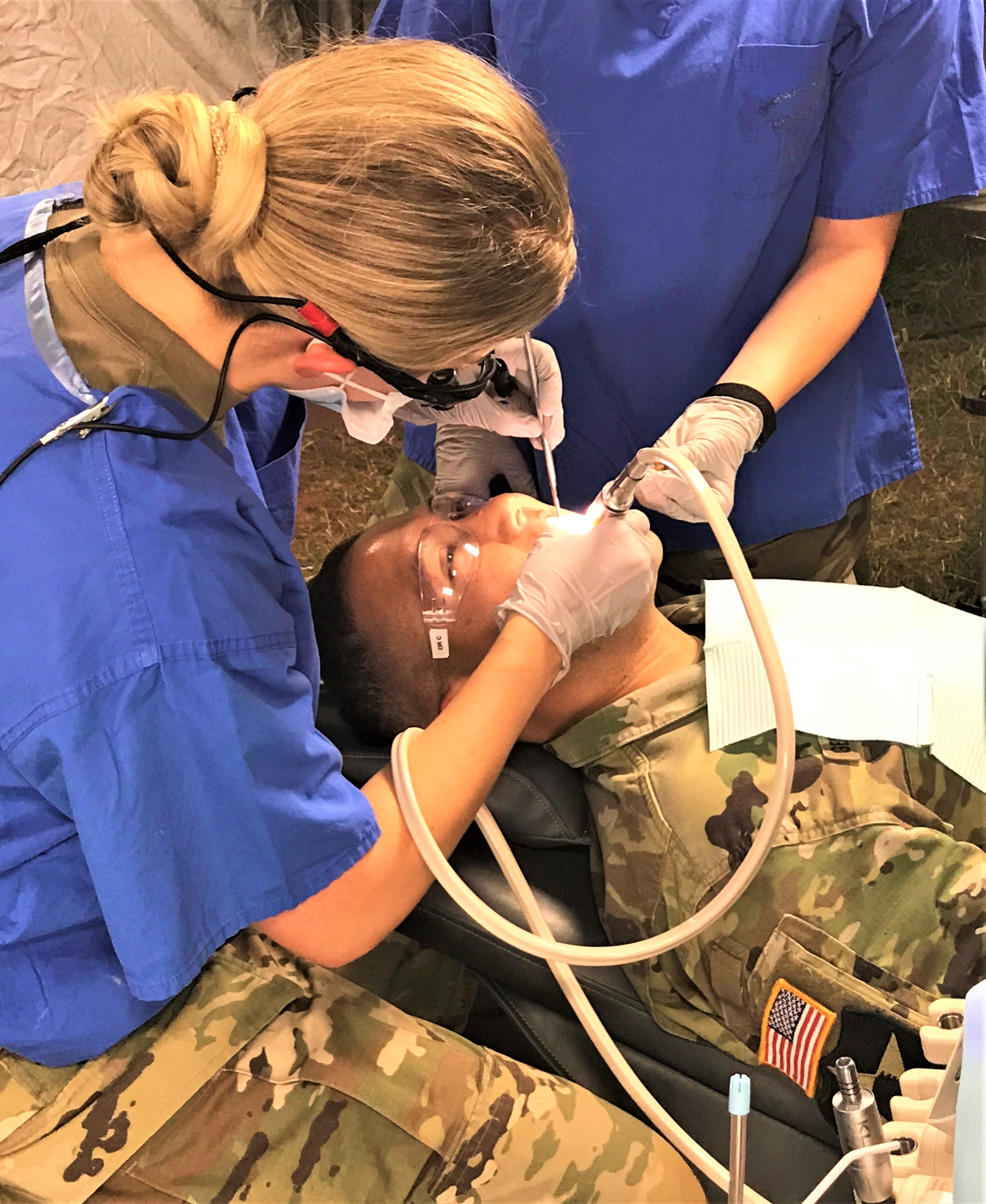 Military dental provider performing services on a military member